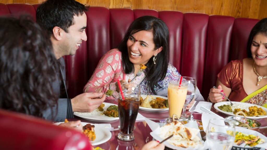 Picture of a happy group of diners enjoying their meal in restaurant - House of India Jena